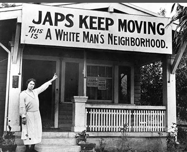 Historic photo of "White Man's Neighborhood" sign from 1920s, from National Japanese American Historical Society collection, found at PBS website, in the public domain.