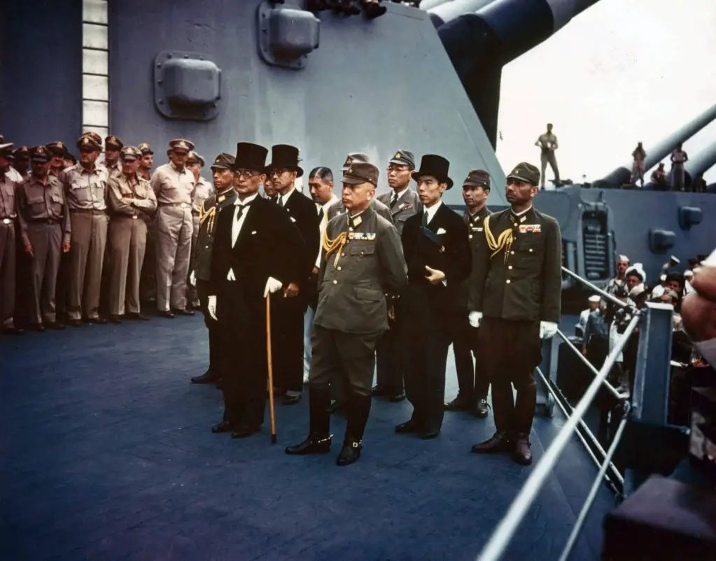 Public domain photo: Japanese officials surrender to the U.S. on the USS Missouri. Army Signal Corps Collection, U.S. National Archives. From Wikimedia Commons.