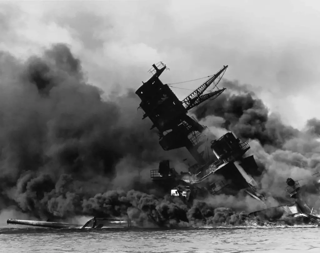 Public domain photo, the USS Arizona after the Japanese attack on Pearl Harbor, from Wikipedia, part of National Archives and Records Administration. Unknown photographer.